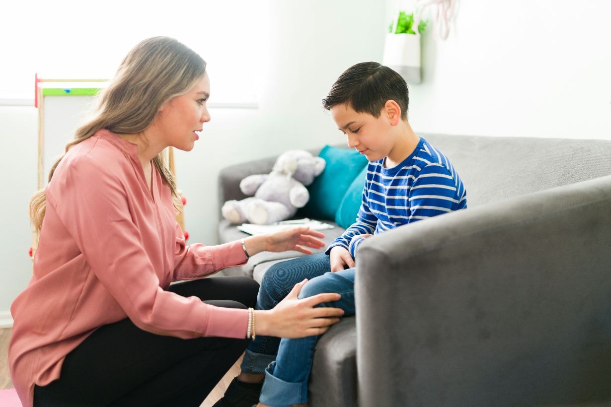 Psychotherapist consoling child